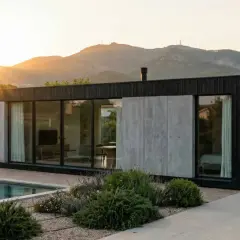Casa moderna con piscina y coche eléctrico, estructura de **steel frame** visible en su diseño minimalista.