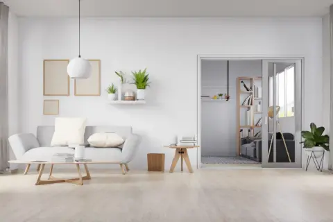Sala de estar minimalista con sofá gris, mesa de centro de madera y suelo de madera clara, mostrando varios tipos de suelo.