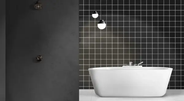 Modern bathroom with a freestanding white tub and a dark tiled wall. Ideal for **revestimiento paredes baño sin obras**.