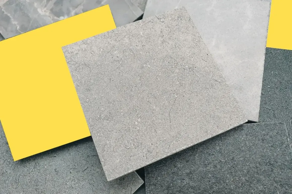 Muestras de suelos de piedra natural en tonos grises y un toque de amarillo vibrante.