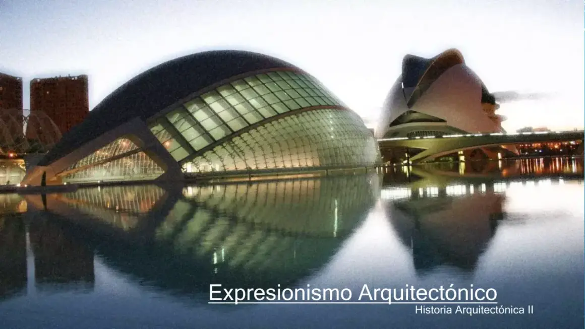Edificios futuristas reflejados en el agua, un ejemplo de expresionismo arquitectónico.