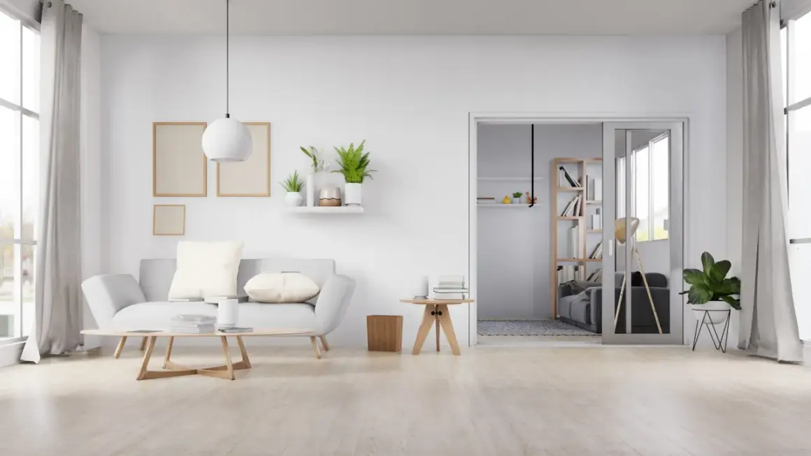 Sala de estar minimalista con sofá gris, mesa de centro de madera y suelo de madera clara, mostrando varios tipos de suelo.