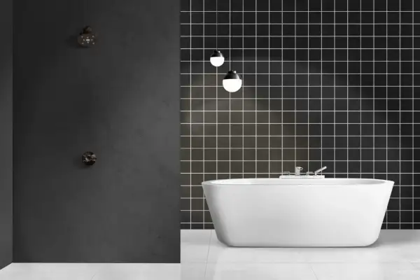 Modern bathroom with a freestanding white tub and a dark tiled wall. Ideal for **revestimiento paredes baño sin obras**.